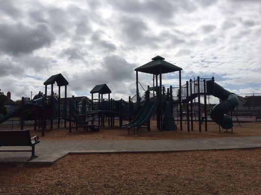 Large playground with 4 large slides. Lots of swings. A tire swing.