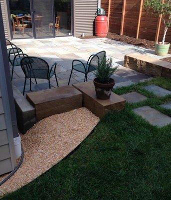 Natural stone tile patio with sandstone slabs, and artificial turf.