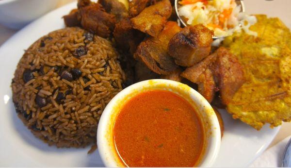 Rice and beans with fried pork and plantains