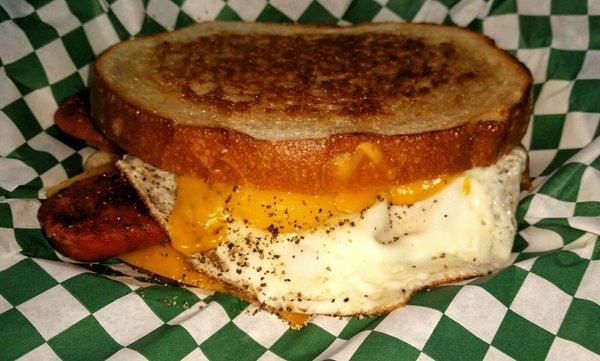 The Hot 'B'! A Hotlink Breakfast Sandwich. Fried Louisiana Hotlink, Fried Egg, Cheddar Cheese, on grilled Boudin Sourdough bread!