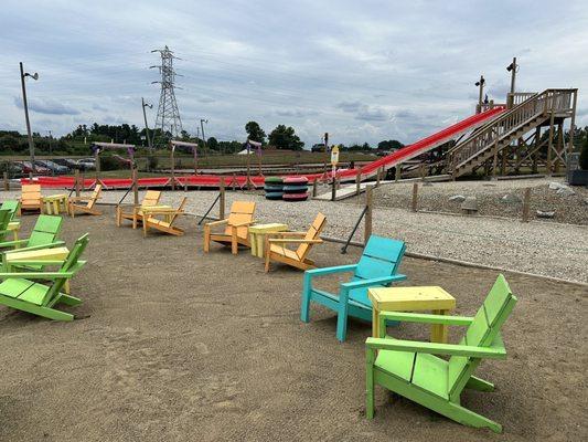 Splash pad seating and tube slide