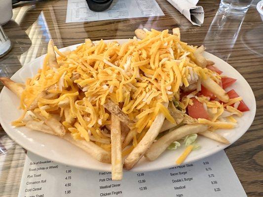 There is a Grilled Chicken Salad under the cheesie fries.