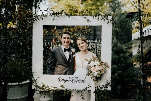 Brigid + David with photo frame at their wedding at 255 Milledge