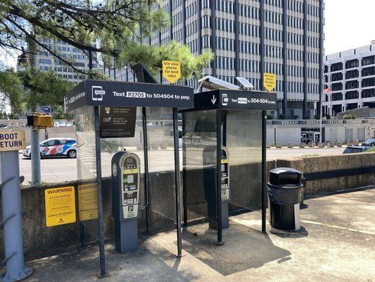 a pair credit card payment stations located near the upper level egress of the parking garage