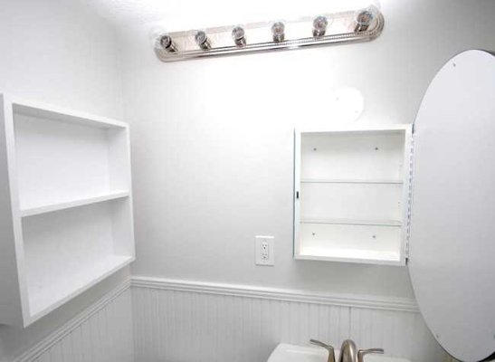 Each bathroom has been renovated with a new bathtub, pedestal sink, and ceramic tile flooring.