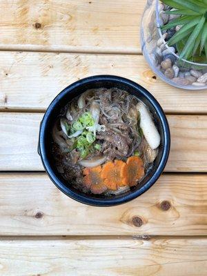 Served in a hot stone pot. Thinly sliced marinated beef loin, glass noodle, rice cake carrots and scallion. Comes with a bowl of rice.