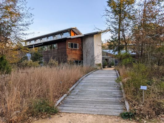 Bridge to Allen Education Center center building (Building B): Visitor Information and Exhibits.