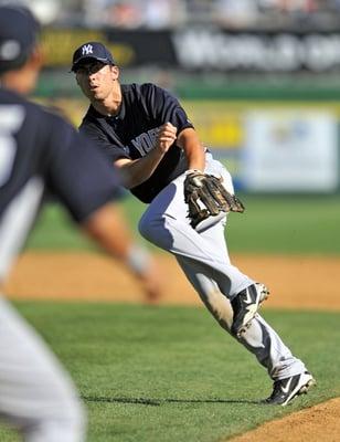 Doug Bernier New York Yankee throws the baseball to get out the runner.  Spring training 2012.  Image by Ed Wolfstein