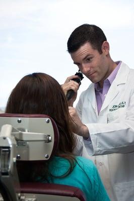 Dr. Mills using fiberoptic scope to examine throat and vocal cords.