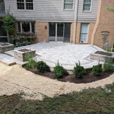 Rochester, Michigan Project showcasing our work of a brick paver patio with wallstone planting boxes