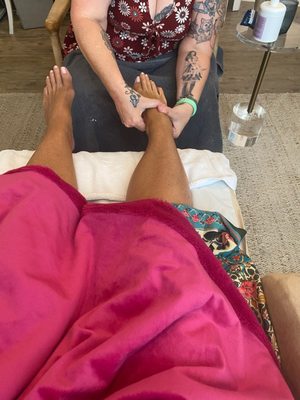 Client enjoying a light foot rub prior to receiving her foot detox.