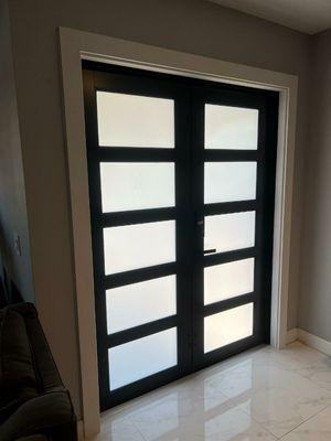 New impact door with frosted glass, fully recessed threshold, tile repairs completed and new interior trim.