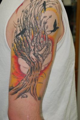 Color tattoo of tree with birds and wind