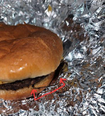 Metal cooked into the burger sticking out