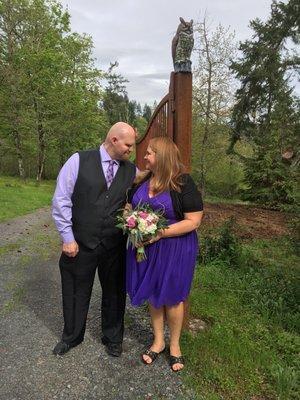 Newlyweds pose by the gate