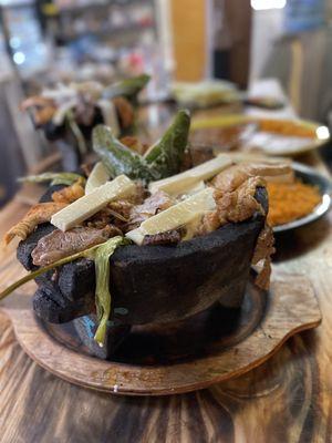 Molcajete.  Hot Volcano dish filled with Grilled steak, Grilled Chicken, Grilled shrimp, Mexican sausage.