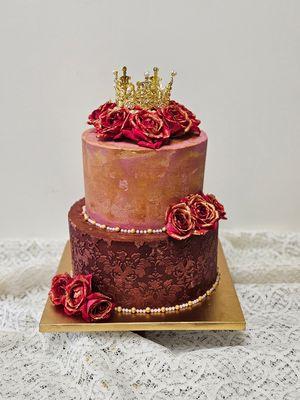 Custom cake featuring fresh roses, pearls and gold crown.