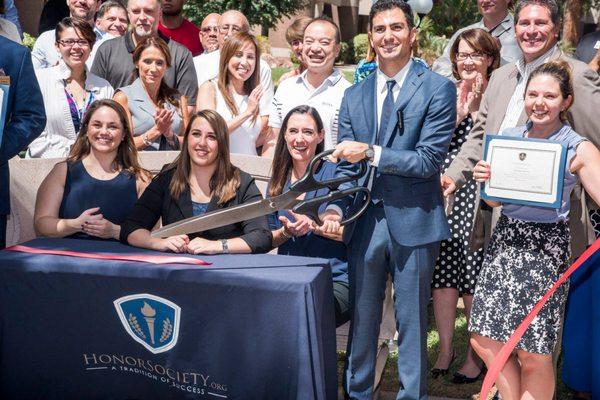 Honor Society ribbon cutting. Those are some big scissors!