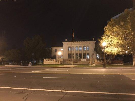 Veterans Memorial Building at night.  Entrances is on the left hand side facing the building from the front.   Look for the awning.