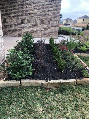 Flower bed with bull rock and plants