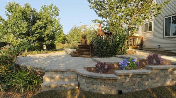 Large brick paver patio with steps and walls.