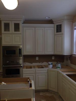 Mid-construction: double cabinet, crown molding, and tile floor.