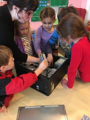 Our classes are hands-on and collaborative.  Here, 1st-3rd graders learn how to take apart and reassemble a computer.