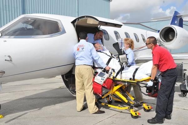 Advanced Air Ambulance. 
Medical Staff & Crew Smoothly and Comfortably Helping to Transfer a Patient onto the Air Ambulance Aircraft.