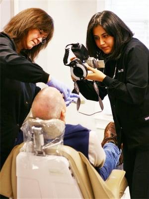 Dr. Patel and her dental assistant, Patty, with a patient