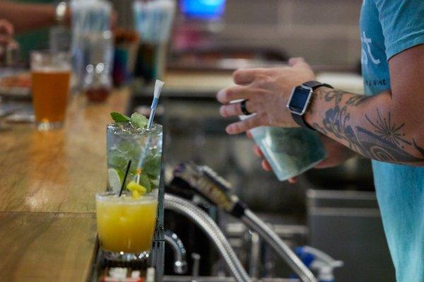 Coconut Mojito, made with Single Prop Rum, triple mint simple syrup, muddled lime & mint, soda water & garnished with a fresh mint sprig.