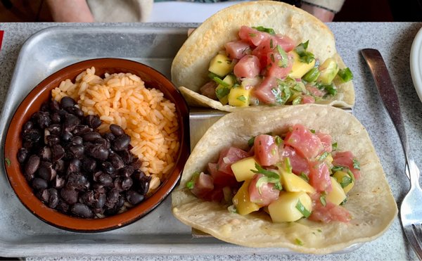 Raw tuna tacos with rice and beans.