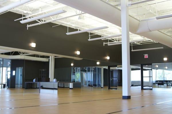 High ceiling, floor to ceiling mirrors and large windows for lots of natural light in our yoga room