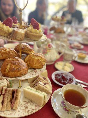 Three tiered nibbles - sweets, scones and ginger sandwiches