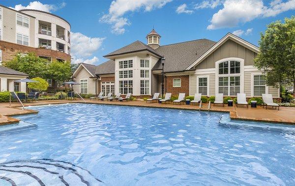 Sparkling swimming pool with expansive sundeck and cabana