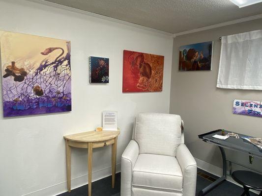 Four of Selena Valenti's paintings in her studio space.