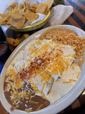 Chicken enchiladas with rice and beans.