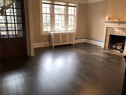 Existing hardwood and subflooring removed, new plywood with leveling installed. And Prefinished engineered wood floor installed on top.