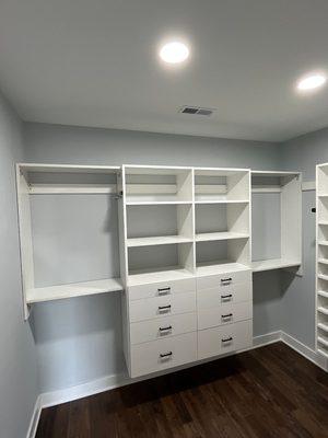 Master closet with double hang and drawers and shelves.