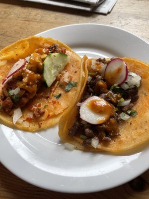 Two tacos: one Al Pastor and one Carne Asada.