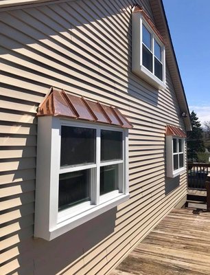 Harry A. Starr & Son job with siding, new windows and copper awnings.