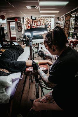 Shannon with Red Letter Tattoo working on a customer.