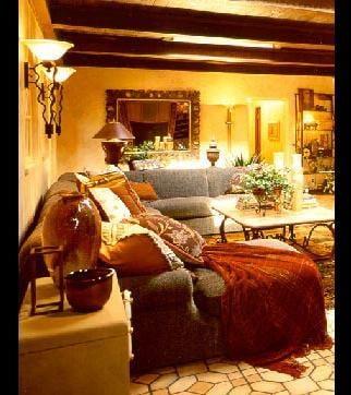 Antique Turkish area rugs introduce a soft ambiance to this over-sized family room.