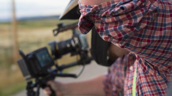 Filming a motorcycle chase shot for a second day wedding shoot for their Bozeman Montana wedding video.