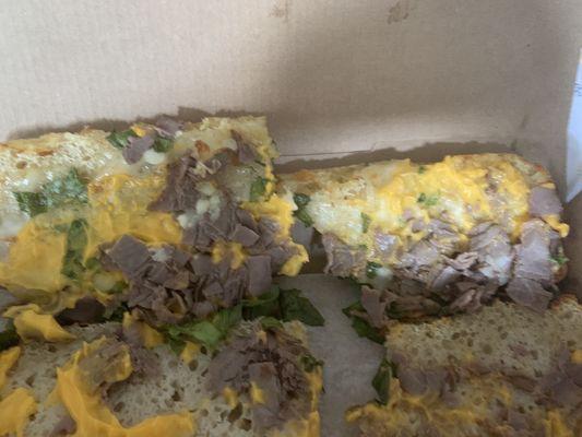 The inside of a Philly Cheesesteak Sub (Whole). This is how much meat was in the sand which.