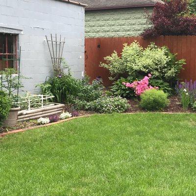 Gate is at the left end connecting to garage