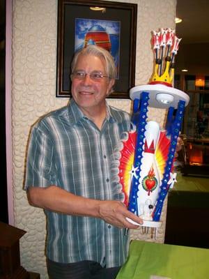 Jeffrey Coleson holding his Googie art sculpture titled The Virgin of Guacamole Lanes