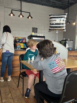 Two kids battling it out for bragging rights at one of the "Family Chess Night" events.