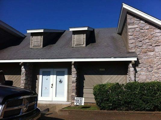 Business exterior...orange cones will be in front of building with one space open for client to pull right up to the door