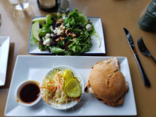 Gluten free grilled chicken sandwich with Louisiana hot sauce. House salad