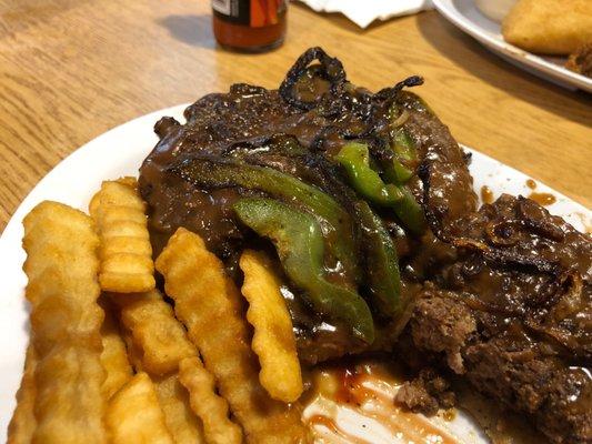 Open face made with handmade patties with bell pepper and onions with fries